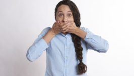 woman covering her mouth in surprise